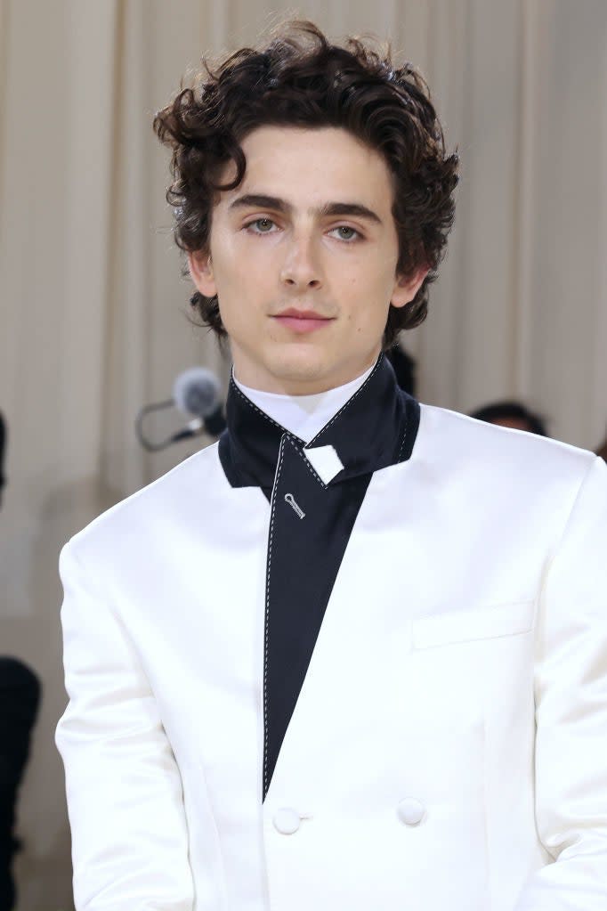 Timothée Chalamet wearing a white tuxedo jacket with a black bow tie