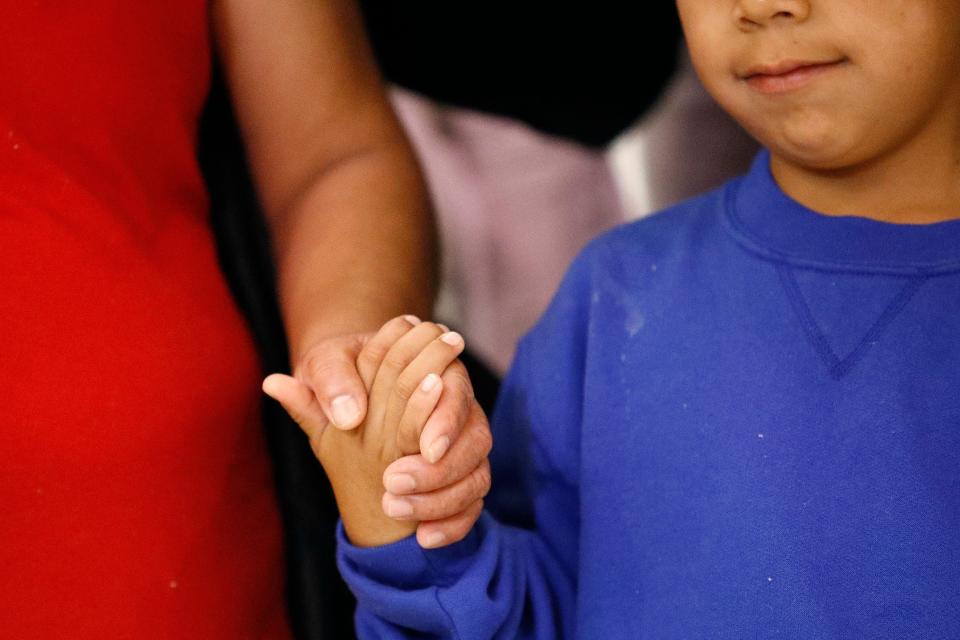 A mother and son from Guatemala hold hands during a news conference on  June 22, 2018, following their reunion in Linthicum, Md., after being separated at the U.S. border under the Trump administration's "zero tolerance" immigration enforcement policy.