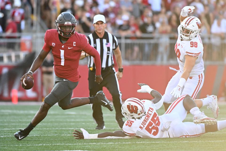 Sep 9, 2023; Pullman, Washington, USA; Washington State Cougars quarterback Cameron Ward (1) is chased out of the pocket by Wisconsin Badgers linebacker Maema Njongmeta (55) in the first half at Gesa Field at Martin Stadium. Mandatory Credit: James Snook-USA TODAY Sports