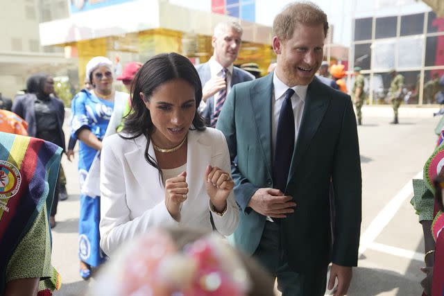 <p>AP Photo/Sunday Alamba</p> Meghan Markle and Prince Harry at the Nigerian Defence Headquarters in Abuja