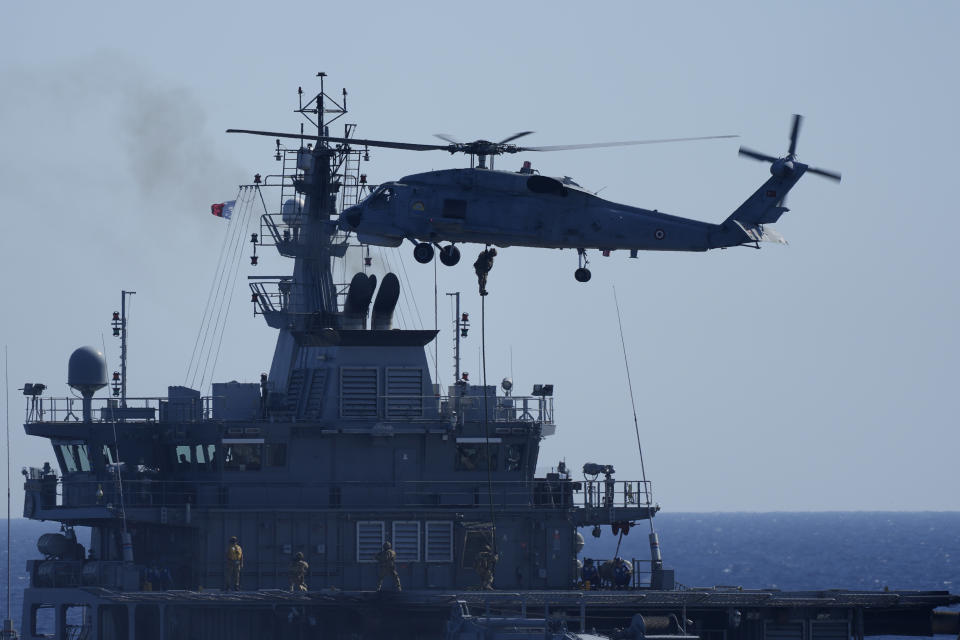 FILE - A military helicopter loads marines over a naval ship during an annual NATO naval exercise on Turkey's western coast on the Mediterranean, Thursday, Sept. 15, 2022. NATO is conducting the biggest revamp of its defense plans since the Cold War in case Russian President Vladimir Putin decides to widen the conflict outside Ukraine. Right now, some 40,000 troops are on standby from Estonia in the north down to Romania on the Black Sea. (AP Photo/Khalil Hamra, File)