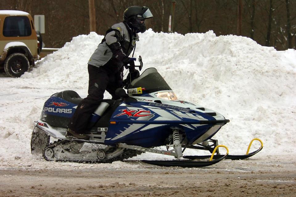 A snowmobiler heads for a trail after getting fuel at a gas station on Main Street in Forest City, Pa., on Wednesday, Feb. 5, 2014, after a winter snow storm. (AP Photo/The Scranton Times-Tribune, Butch Comegys) WILKES BARRE TIMES-LEADER OUT; MANDATORY CREDIT.