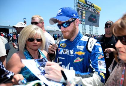 Dale Earnhardt Jr. signs autographs during qualifying for Sunday&#39;s NASCAR Sprint Cup Series auto race at Talladega Superspeedway, Saturday, May 2, 2015, in Talladega, Ala. (AP Photo/David Tulis)