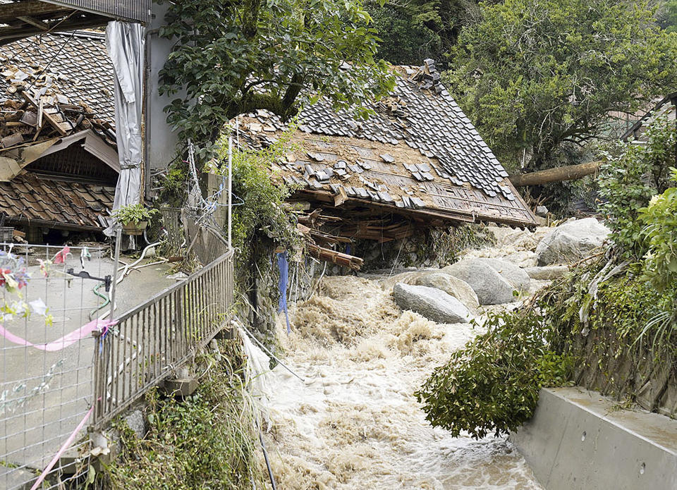 This shows a house damaged by a landslide in Karatsu, Saga prefecture, southern Japan Monday, July 10, 2023. Torrential rain has been pounding southwestern Japan, triggering floods and mudslides. (Kyodo News via AP)