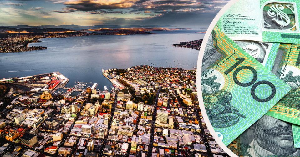 Aerial view of downtown Hobart and Australian $100 notes staked ut top of each other.