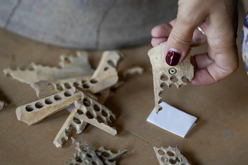 An archeologist shows pieces of bone used to carve Christian rosary beads, approximately dated to the 14th century A.D., coming from the excavation of ancient Roman emperor Nero's theater, during a press preview, in Rome, Wednesday, July 26, 2023. The ruins of Nero's Theater, an imperial theater referred to ancient Roman texts but never found, have been discovered under the garden of the future Four Season's Hotel, steps from the Vatican, after excavating the walled garden of the Palazzo della Rovere since 2020, as part of planned renovations on the Renaissance building. (AP Photo/Andrew Medichini)