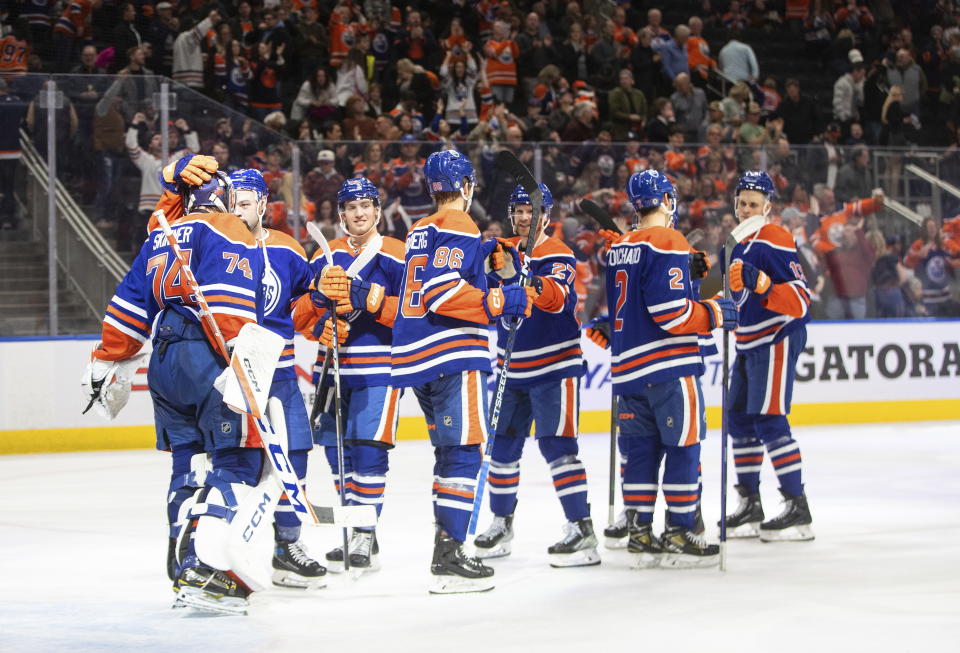 Edmonton Oilers celebrate a win over the Minnesota Wild in an NHL hockey game Friday, Dec. 9, 2022, in Edmonton, Alberta. (Jason Franson/The Canadian Press via AP)