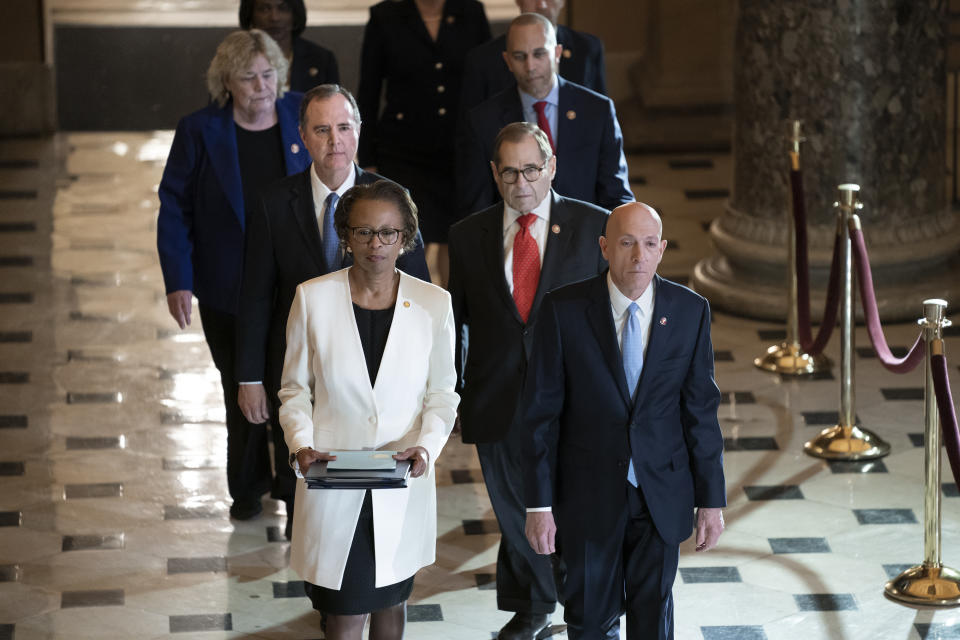 Clerk of the House Cheryl Johnson, left, and House Sergeant at Arms Paul Irving pass through Statuary Hall at the Capitol to deliver the articles of impeachment against President Donald Trump to the Senate, on Capitol Hill in Washington, Wednesday, Jan. 15, 2020. Following are impeachment managers, House Intelligence Committee Chairman Adam Schiff, D-Calif., left, and House Judiciary Committee Chairman Jerrold Nadler, D-N.Y., and other managers Rep. Hakeem Jeffries, D-N.Y., and Rep. Zoe Lofgren, D-Calif. (AP Photo/J. Scott Applewhite)