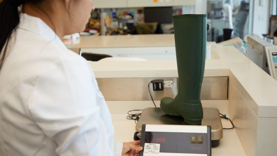 a good housekeeping analyst weighing a rain boot, testing for the best rain boots for women