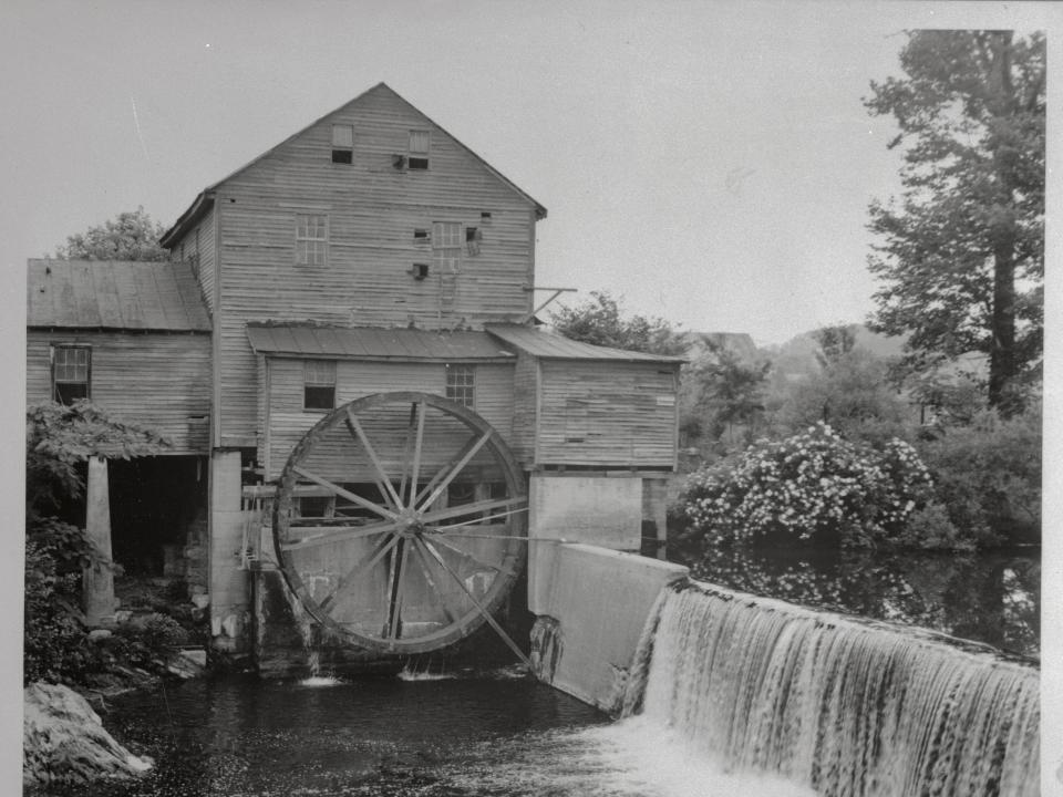 One of the picturesque spots in the Pigeon is this old mill which still runs, built in 1830. The mill has been grinding mountain corn for 135 years using the same French mill stones made of flint granite and weighing over two tons is still in daily operation. The mill building was made of hand hewed pine yellow poplar hemlock and oak held together with hickory pegs.