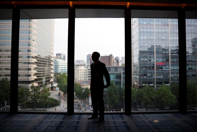 Britain's Foreign Secretary Dominic Raab adjusts his suit before an interview with Reuters in Seoul