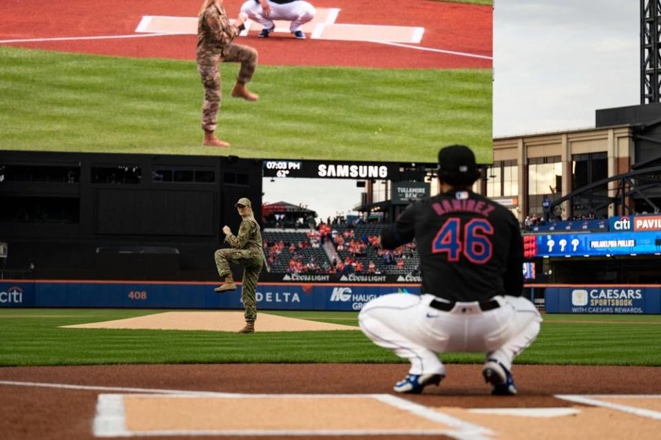 Madison Marsh throws a pitch to a Mets baseball player