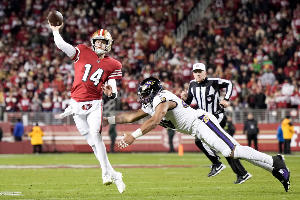 SANTA CLARA, CALIFORNIA – DECEMBER 25: Malik Harrison #40 of the Baltimore Ravens attempts to tackle Sam Darnold #14 of the San Francisco 49ers as he attempts a pass during the fourth quarter at Levi’s Stadium on December 25, 2023 in Santa Clara, California. (Photo by Thearon W. Henderson/Getty Images)