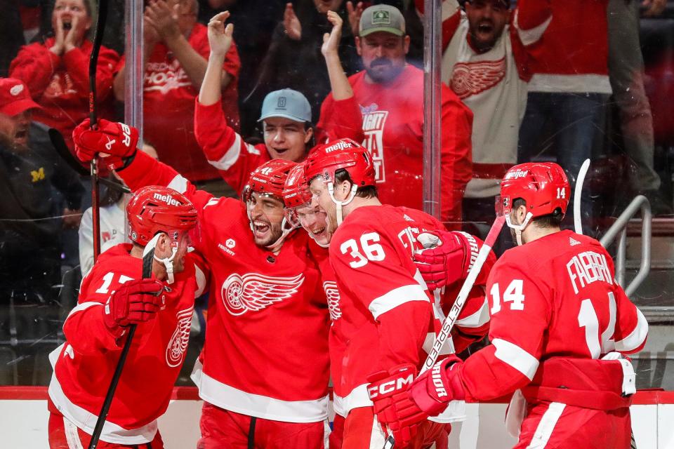 Red Wings players celebrate a goal scored by defenseman Olli Maatta (2) against the Islanders during the third period of the Wings' 5-3 win on Thursday, Feb. 29, 2024, at Little Caesars Arena.