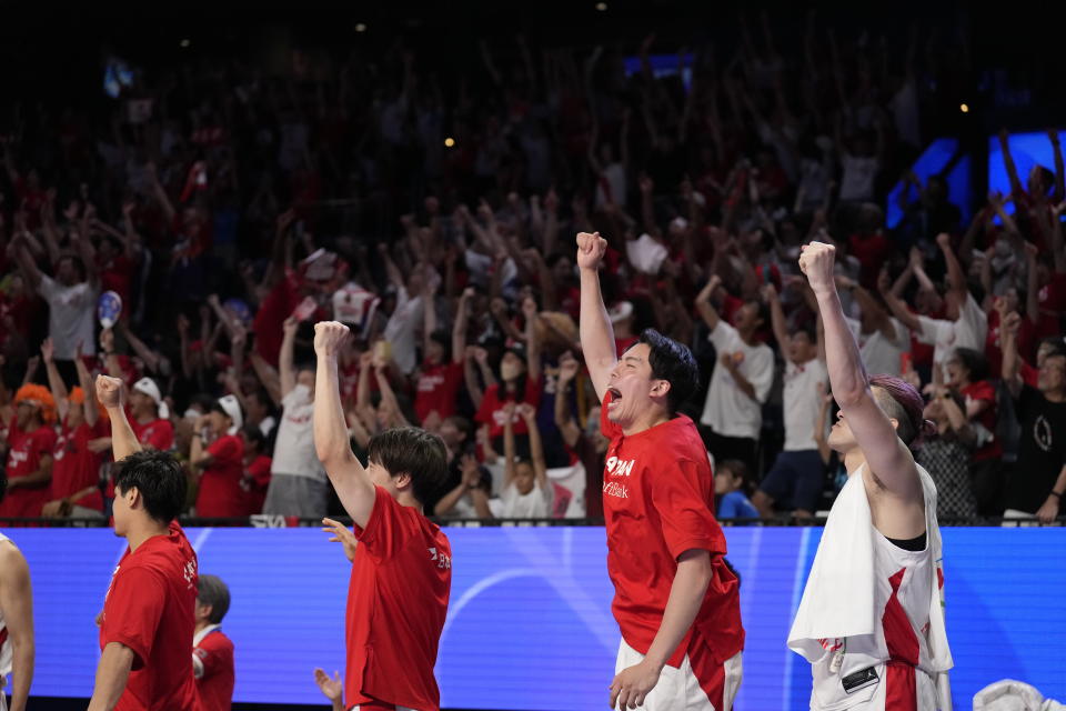 Japan's team members react after the team scored against Venezuela during the first half of the Basketball World Cup classification match in Okinawa, southern Japan, Thursday, Aug. 31, 2023. (AP Photo/Hiro Komae)