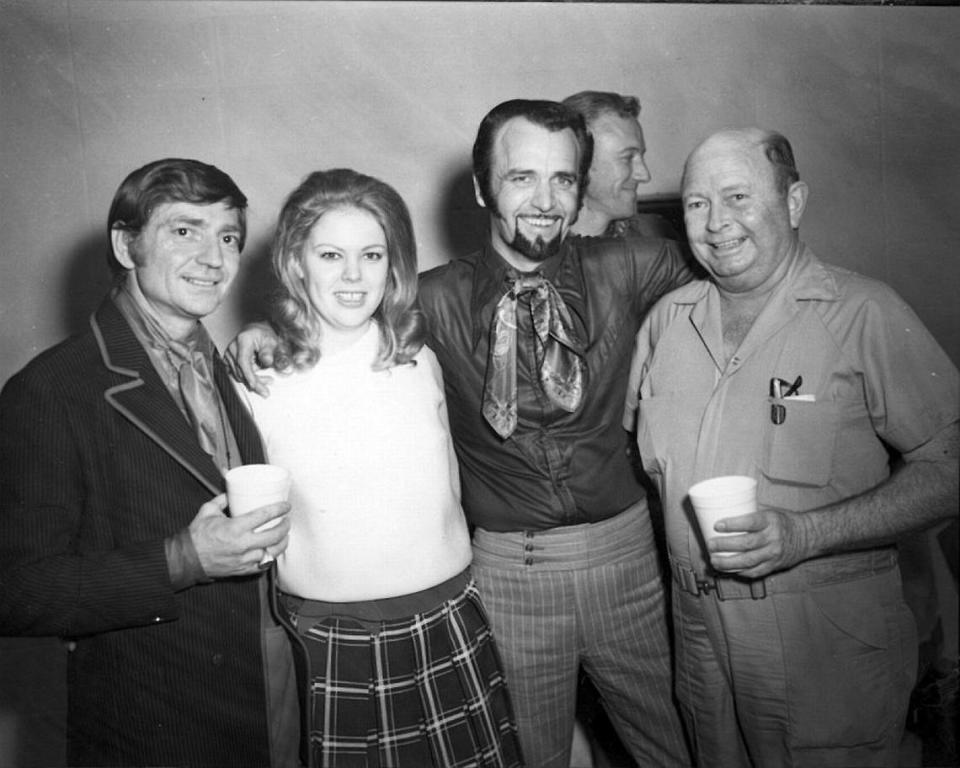 Willie Nelson, left; his drummer Paul English, middle; and Panther Hall owner Corky Kuykendal, far right; are joined by an unidentified fan backstage at Panther Hall.