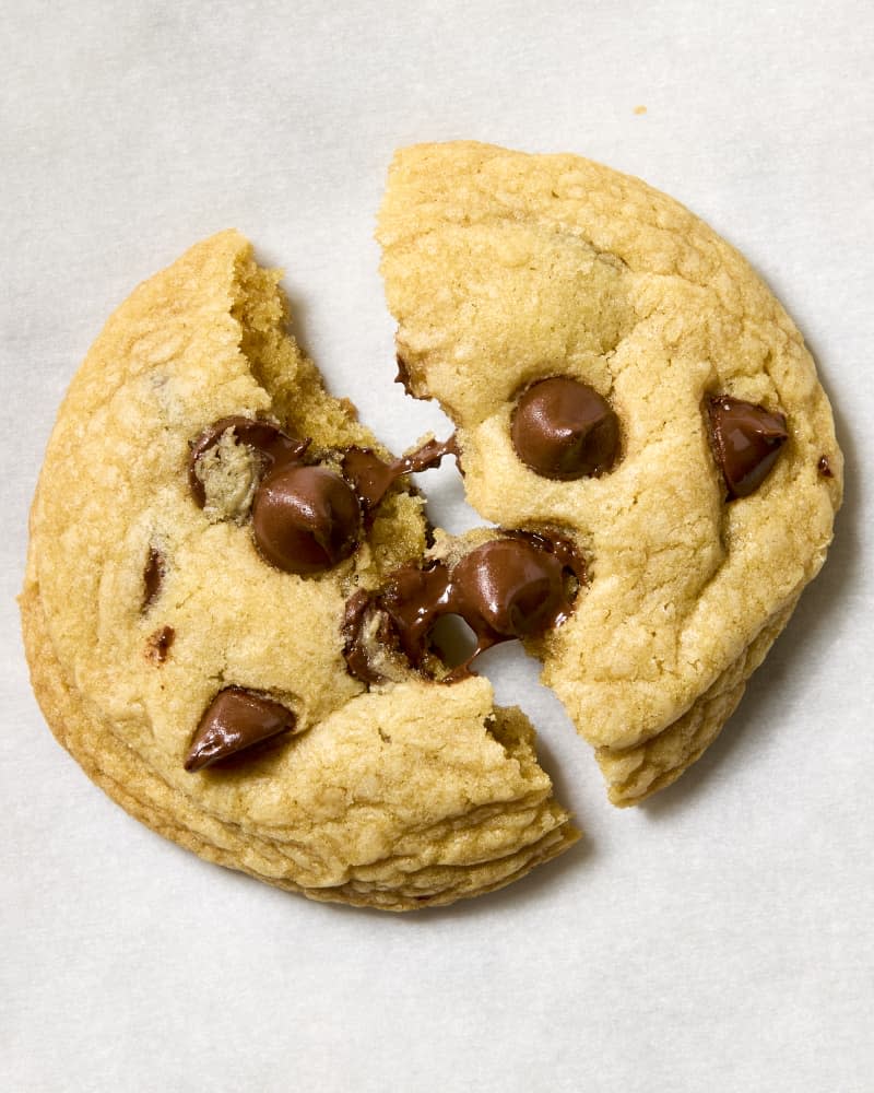 overhead shot of a single broken chocolate chip cookie.