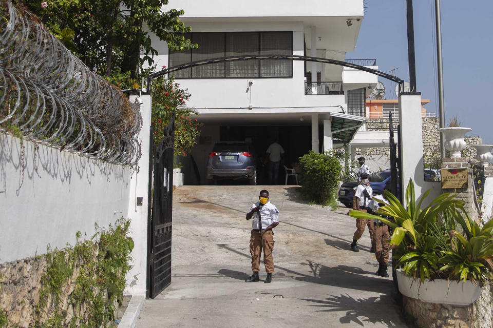 Security guards stand at the entrance to Taiwan's embassy the morning after a break-in, in Port-au-Prince, Haiti, Friday, July 9, 2021, two days after the Haitian president was assassinated. Taiwan's foreign ministry says Haitian police have arrested suspects who tried to break into its embassy but gave no details of the suspects' identities or a reason for the break-in. (AP Photo/Joseph Odelyn)