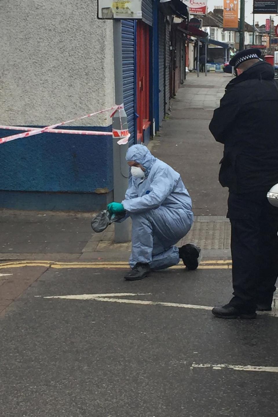 A forensic officer at the scene of the shooting