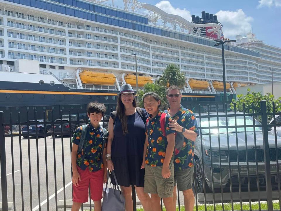 Jill and her family in front of the Disney Wish cruise ship.