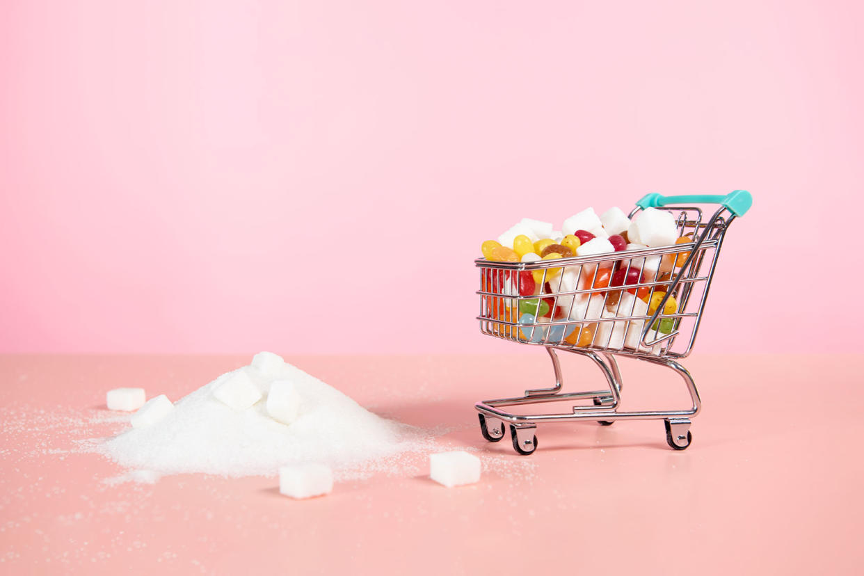 Supermarket trolley with candy next to pile of sugar Getty Images/Tara Moore