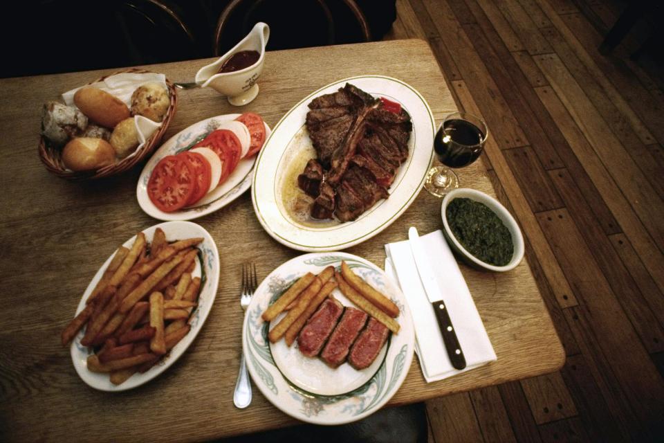 <strong>The Reviewer: </strong>Pete Wells, <em>The New York Times</em><strong> Choice Cuts: </strong>Wells has not always hated the well-known steakhouse. At the start of his <a href="https://www.nytimes.com/2019/10/29/dining/peter-luger-review-pete-wells.html" rel="nofollow noopener" target="_blank" data-ylk="slk:brutal zero-star review;elm:context_link;itc:0;sec:content-canvas" class="link ">brutal zero-star review</a>, he recalls happily emptying out his wallet to eat one of their sizzling porterhouse or rib steaks in the 1990s. “Because a Peter Luger steak made me feel alive in a way that few other things did, I considered this a fair trade.” But a visit back in October 2019, did not encourage the same exchange. He likens the shrimp cocktail to “cold latex dipped in ketchup and horseradish,” calls the dole “dry and almost powder,” and the Caesar salad “drippy” with croutons straight out of the bag. “I know there was a time the German fried potatoes were brown and crunchy, because I eagerly ate them each time I went,” he writes. “Now they are mushy, dingy, gray and sometimes cold. I look forward to them the way I look forward to finding a new, irregularly shaped mole.” His porterhouse was equally disappointing. Though he "could live" with its ranging degree of doneness despite his request for medium-rare, Wells still called the meat “far from the best New York has to offer.” <strong>The Pièce de Résistance: </strong>“There is almost always a wait, with or without a reservation, and there is almost always a long line of supplicants against the wall. A kind word or reassuring smile from somebody on staff would help the time pass. The smile never comes. The Department of Motor Vehicles is a block party compared with the line at Peter Luger.”