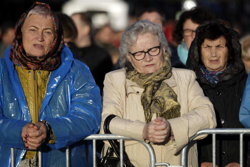 People wait for the arrival of Pope Francis to celebrate mass, at the Santakos Park, in Kaunas, Lithuania, Sunday, Sept. 23, 2018. (AP Photo/Andrew Medichini)