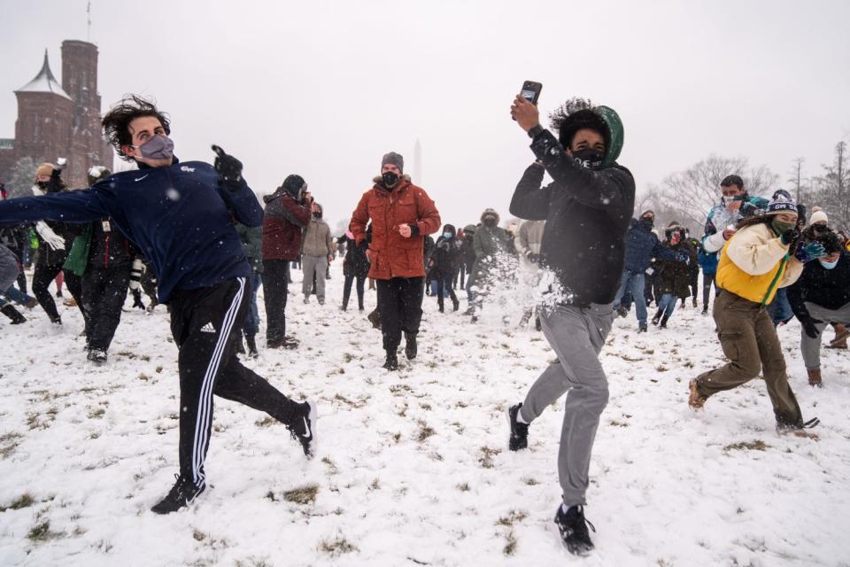 People take part in a snowball fight