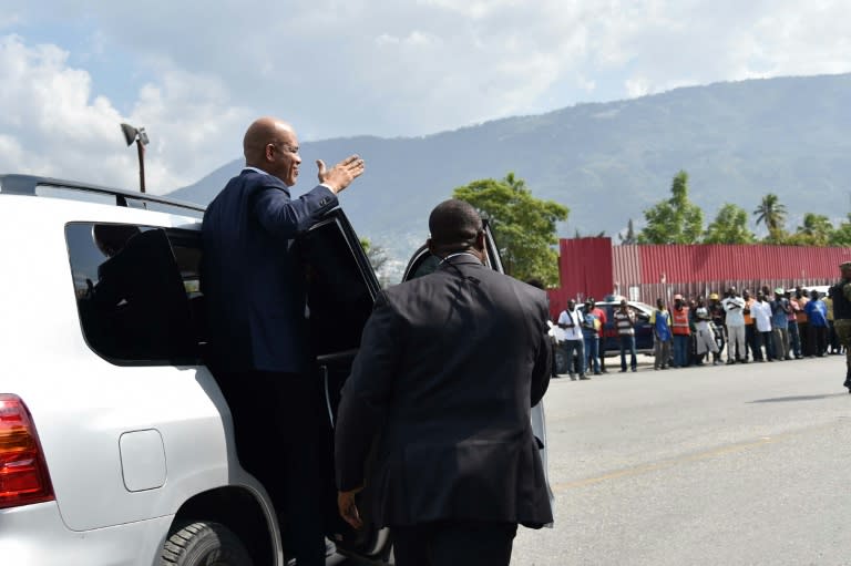 Haitian President Michel Martelly greets supporters as he departs the Parliament after delivering his farewell speech on February 7, 2016 in Port-au-Prince