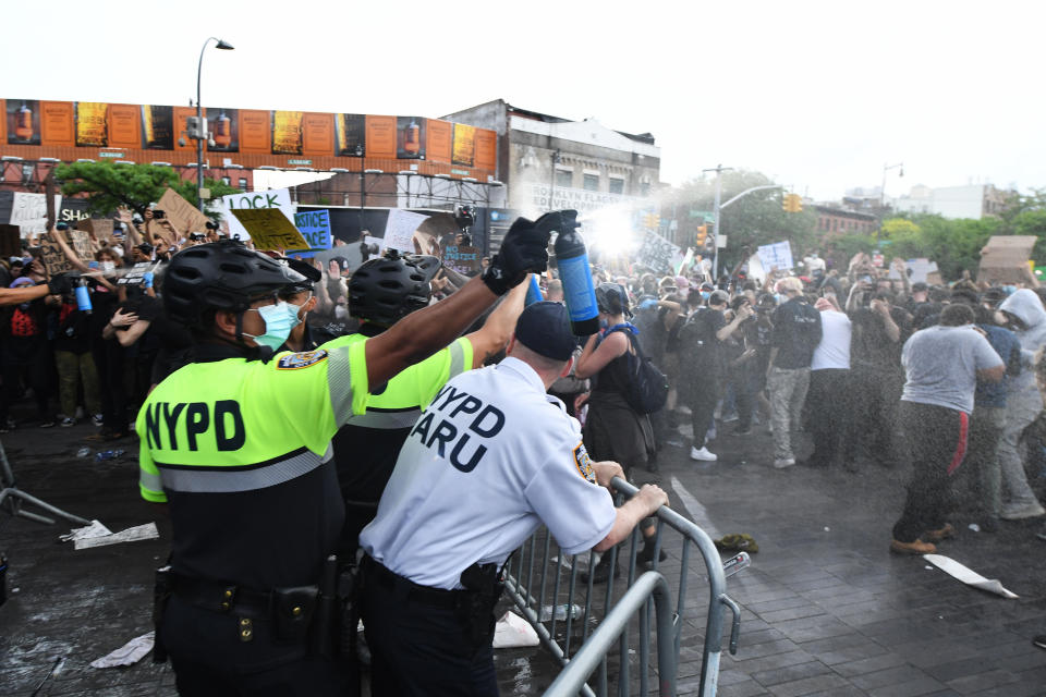 NYPD officers spray Mace into a crowd of protesters on May 29, 2020. / Credit: (C)Kevin Mazur / Getty Images