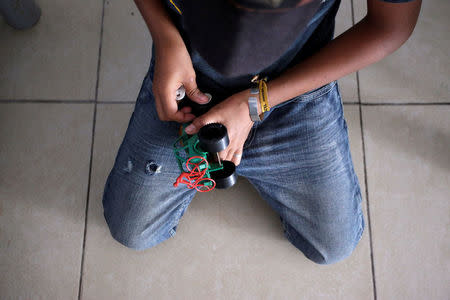 A Mexican migrant child plays with a toy car at the Senda de Vida migrant shelter in Reynosa, in Tamaulipas state, Mexico June 22, 2018. Picture taken June 22, 2018. REUTERS/Daniel Becerril