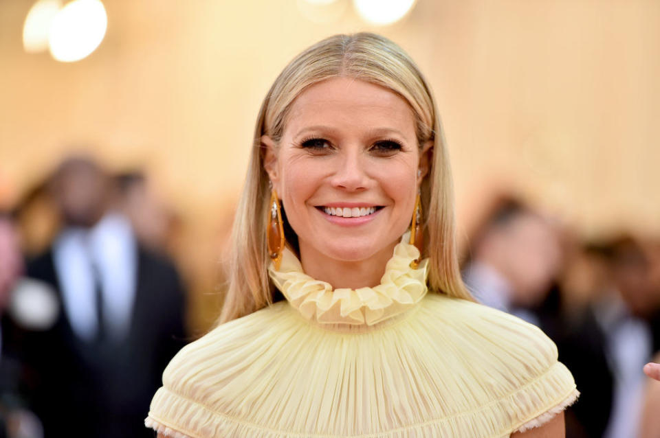 Gwyneth wearing a ruffle-collar top and smiling