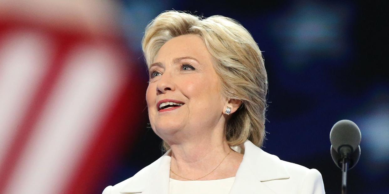 Hillary Clinton smiles at a podium.