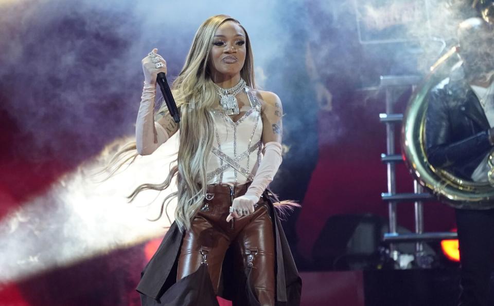 A woman with long hair performs onstage