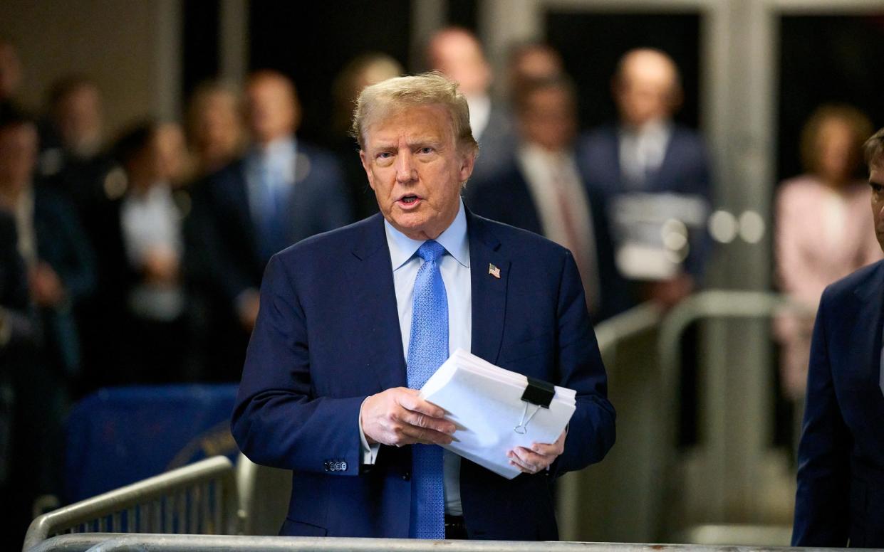 Donald Trump speaks to the press as he arrives for his trial