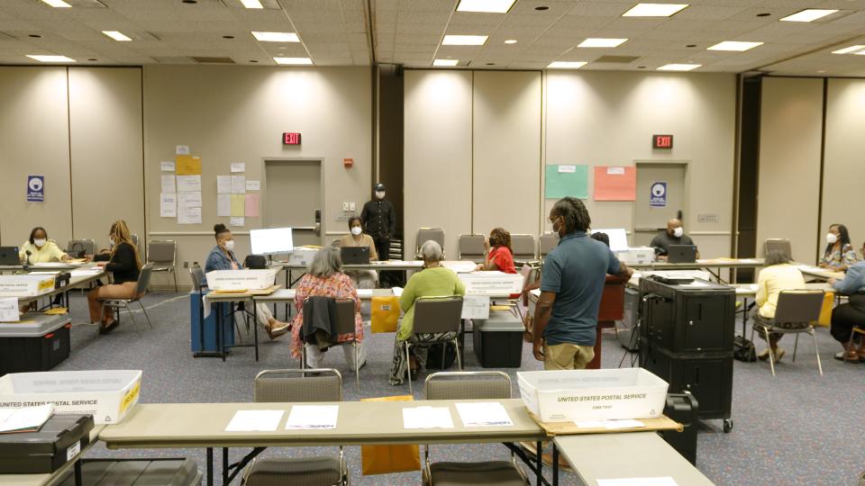 At an election worker training in Detroit, attendees review the steps for processing absentee ballots ahead of the Aug. 2, 2022 primary.