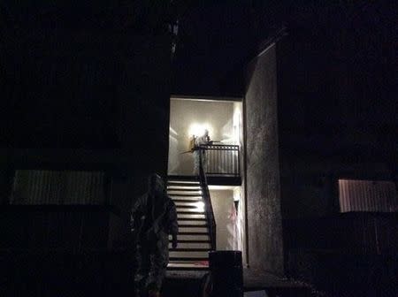 Emergency personnel wearing protective clothing approach a residential apartment after a second healthcare worker tested positive for the Ebola virus in Dallas, in a photo provided by the Dallas Police Department October 15, 2014. REUTERS/Dallas Police Department/handout via Reuters