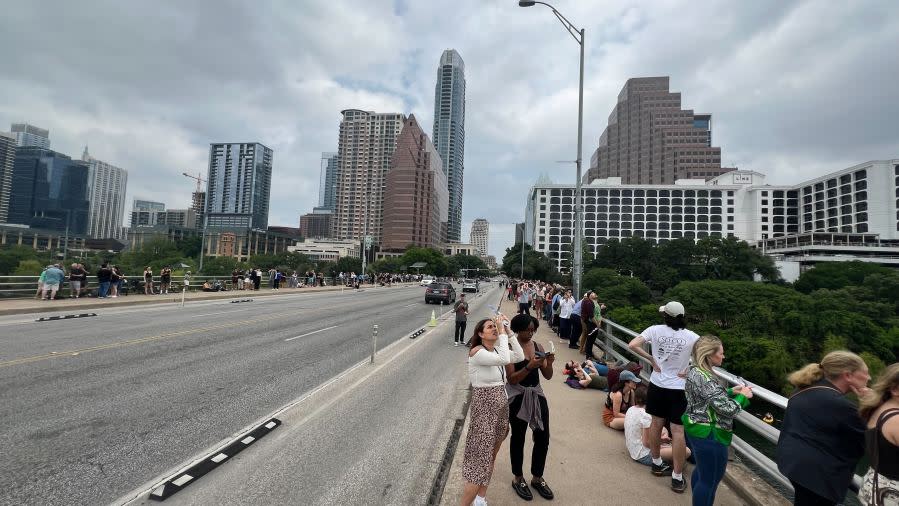 Folks watch the total solar eclipse from the Congress Avenue bridge in Austin, Texas, on April 8. (KXAN Photo/Andy Way)