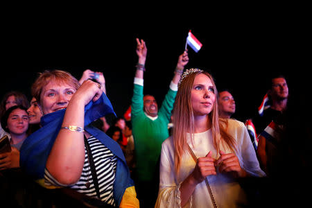 Fans watch on a big screen the 2019 Eurovision song contest final, in the fan zone by the beach in Tel Aviv, Israel May 18, 2019. REUTERS/Corinna Kern