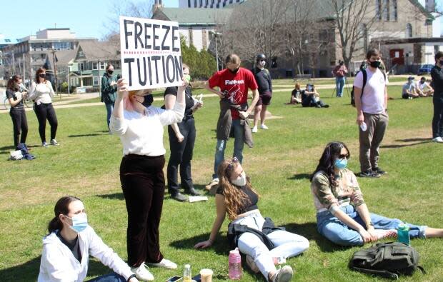 Trulee Love, incoming Dalhousie Student Union vice president internal, holds a sign during a student rally on April 20. (Dalhousie Student Union - image credit)