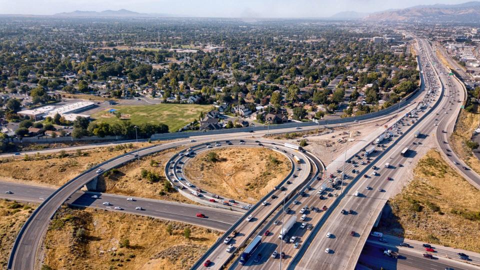 Sweeping drone view from above of the busy streets and freeways in and around Salt Lake City.