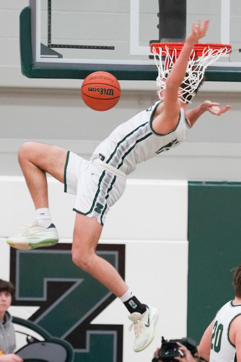 Zionsville Eagles Drew Snively (11) dunks the ball Tuesday, Feb. 6, 2024, during the game at Zionsville High School in Zionsville, Indiana. The Center Grove Trojans defeated the Zionsville Eagles 60-49.