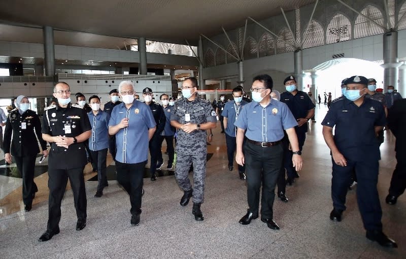 Home Minister Datuk Seri Hamzah Zainudin (3rd left) during his visit to the Bangunan Sultan Iskandar building that houses the customs, immigration and quarantine (CIQ) facility in Johor Baru April 7, 2020. — Picture by Ben Tan