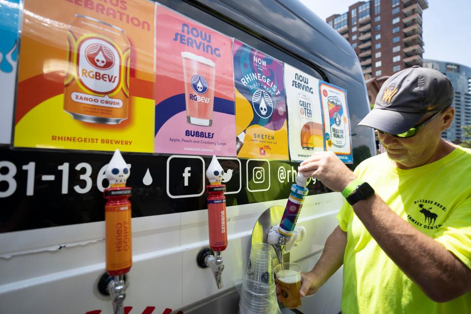 Dave Himmelrick, volunteering with the Hilliard Moose Lodge, pours a Sketch beer on Friday at the Columbus Arts Festival in downtown Columbus. The beer was newly created by Cincinnati-based Rhinegeist in honor of the festival.