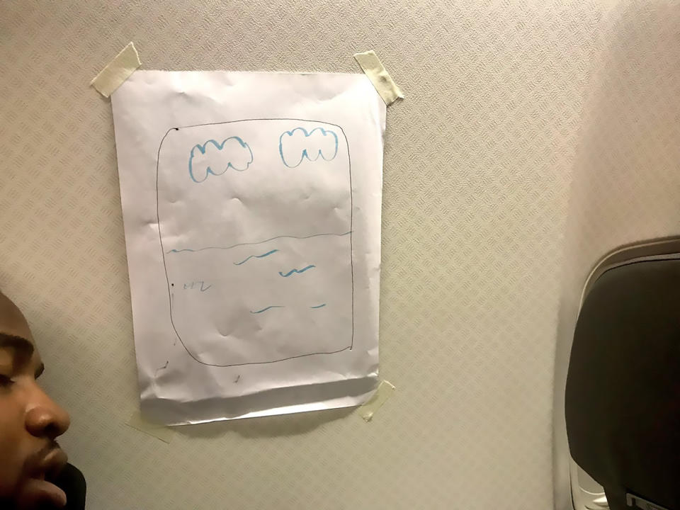 The passenger had reportedly booked a window seat on an internal flight in Japan but found himself sitting next to a blank wall. So the hostie drew him one and taping it to the wall. Photo: Australscope