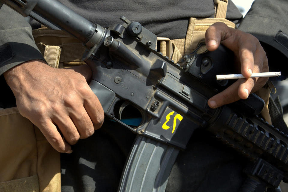 Soldier clutches his weapon in Iraq