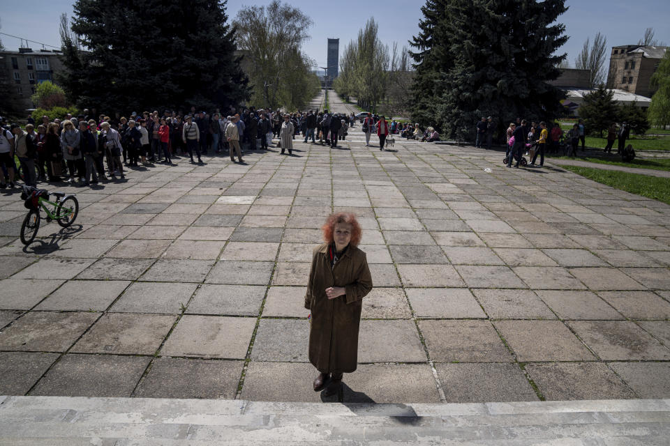 Local residents stand in line to receive drinking water at a distribution centre in Toretsk, eastern Ukraine, Monday, April 25, 2022. Toretsk residents have had no access to water for more than two months because of the war. (AP Photo/Evgeniy Maloletka)