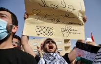 Jordanians demonstrate to express solidarity with the Palestinian people, near the Israeli embassy in Amman