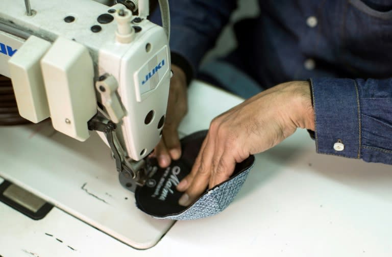 A Palestinian man in a factory in Hamas-run Gaza uses a sewing machine to finish off a Jewish skullcap for export to Israel