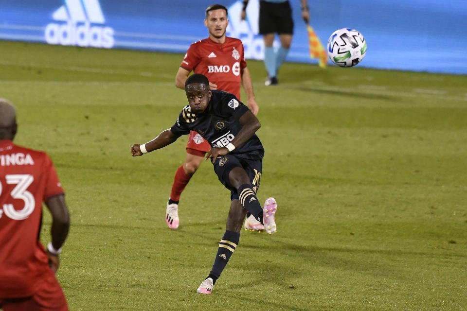 Philadelphia Union's Jamiro Monteiro, center, takes a shot on goal during the first half of an MLS soccer match against Toronto FC, Saturday, Oct. 3, 2020, in East Hartford, Conn. (AP Photo/Jessica Hill)